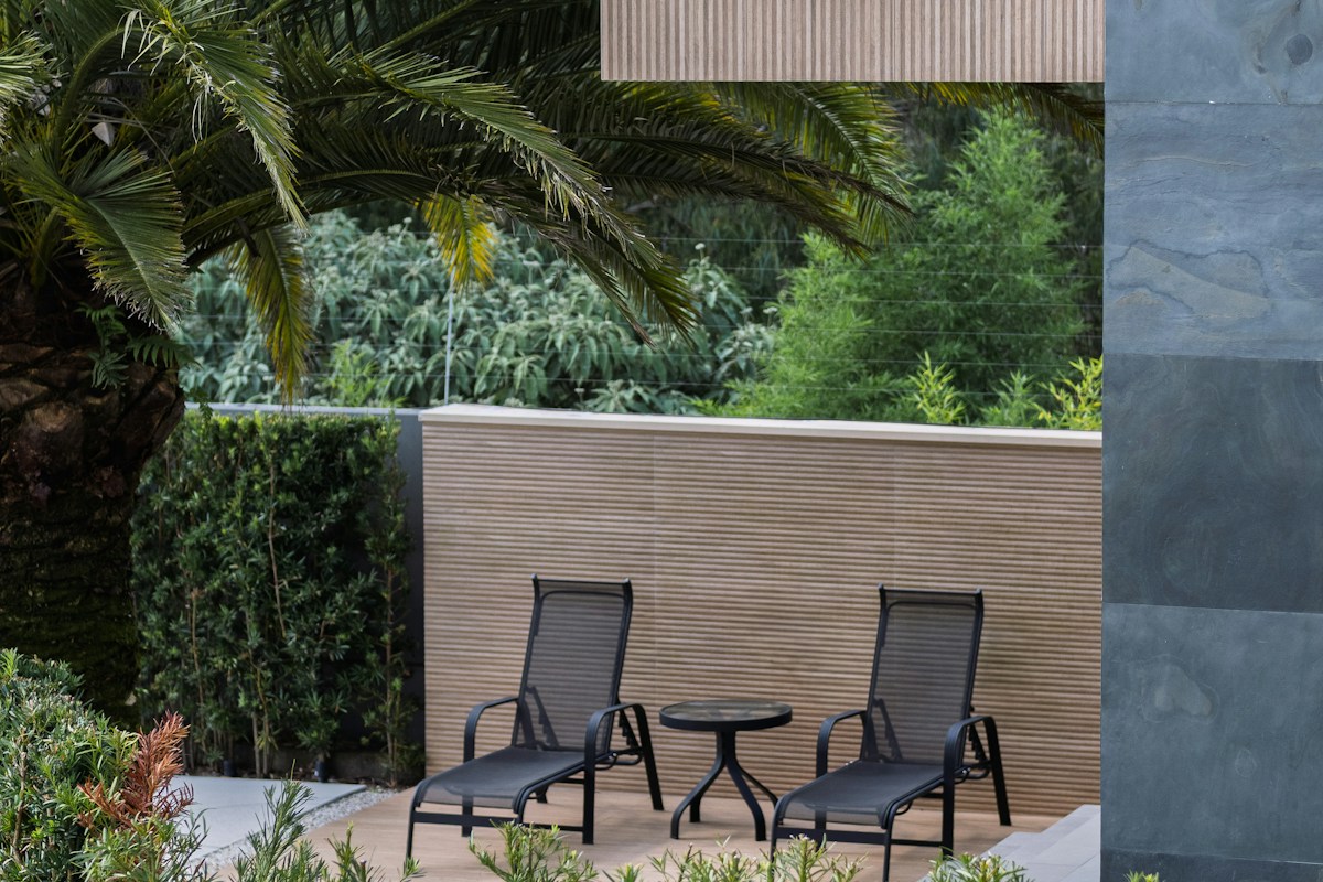 Outdoor chairs on a leafy patio